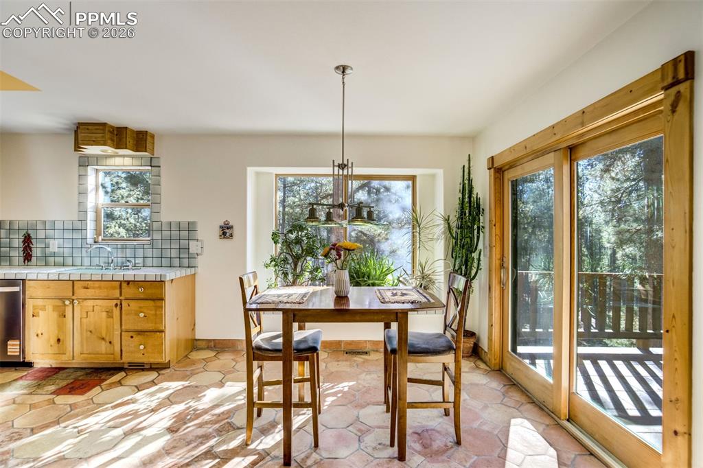 Image 9 of 45: Look at that natural light. Dining area with baseboards and hanging lights