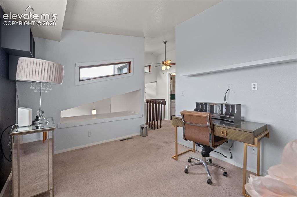 Image 22 of 28: Built-in architectural shelving, a distinct angled window, and light-colore
