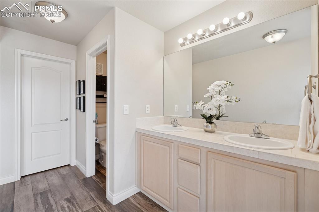Image 11 of 37: En Suite bathroom with dual vanities and walk in closet.
