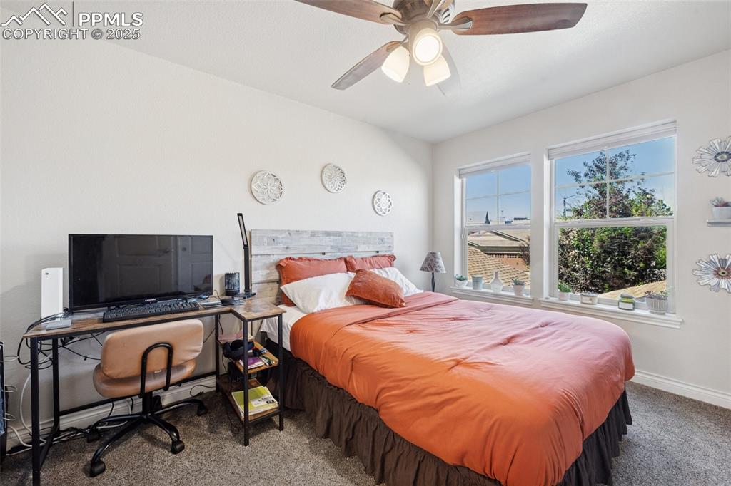Image 12 of 37: Upper level secondary bedroom with attached bathroom. 