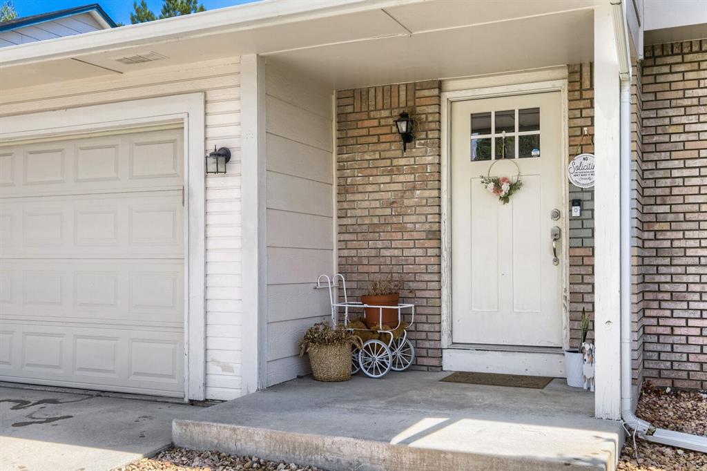 Image 2 of 22: Inviting front entry featuring a white paneled door with glass inserts, com