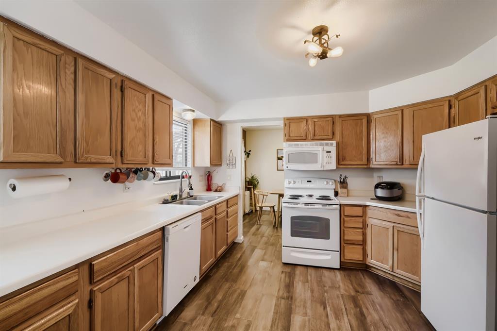 Image 8 of 22: Kitchen featuring wood-finish cabinetry, white countertops, and wood-finish