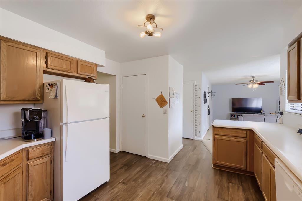 Image 9 of 22: Kitchen featuring wood-finish flooring, white countertops, and wood cabinet