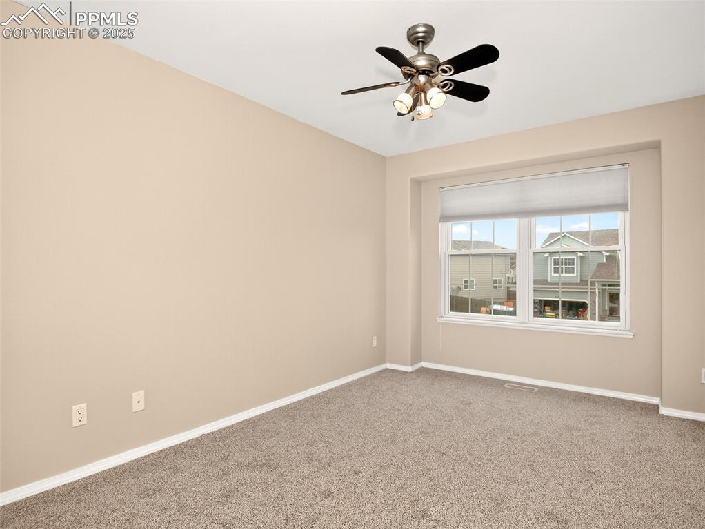 Image 19 of 27: Empty room featuring carpet flooring and ceiling fan