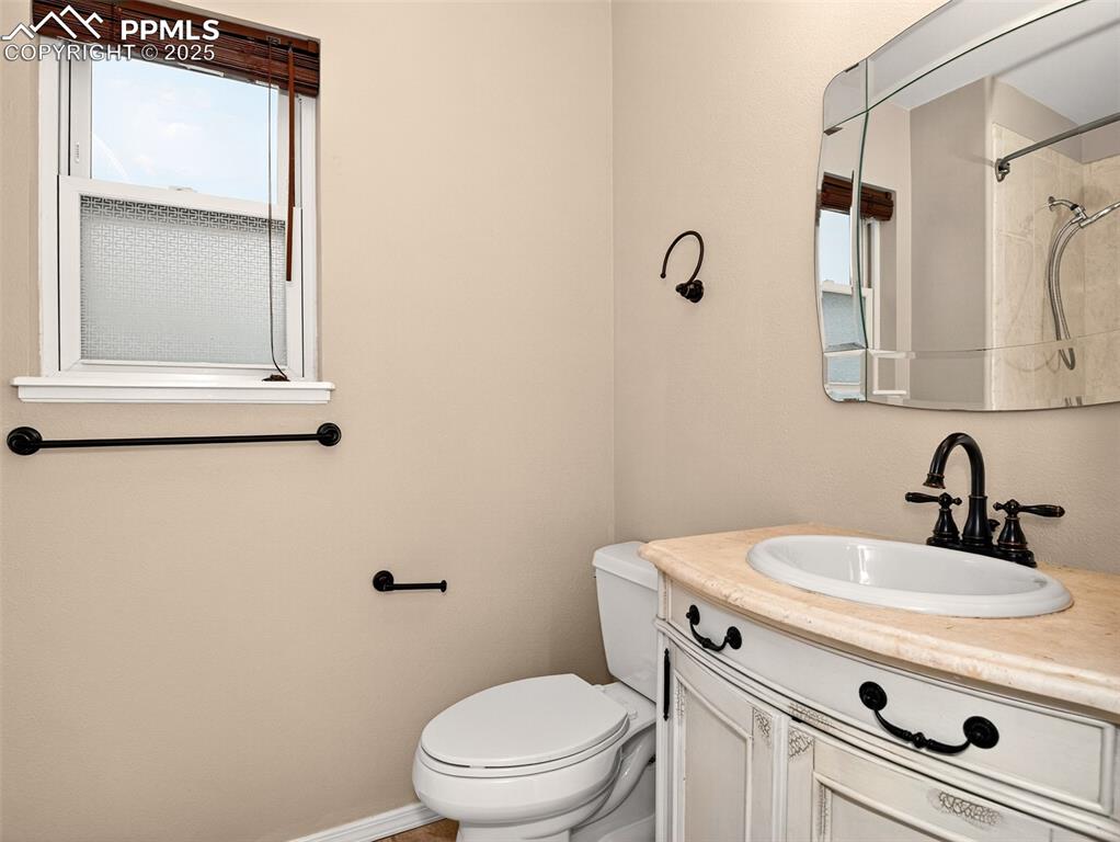 Image 21 of 27: Full bath with vanity and a shower