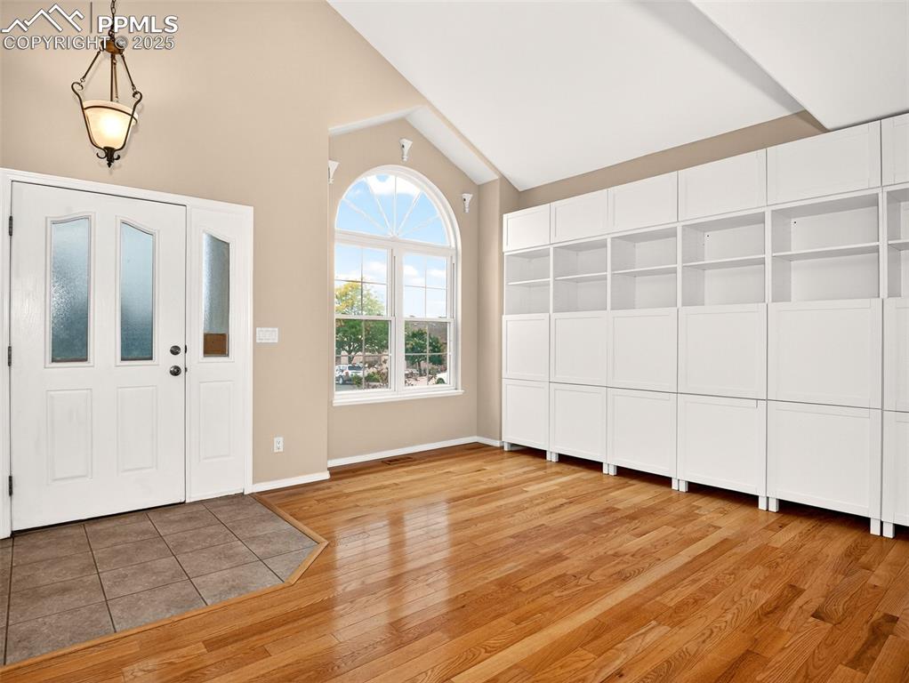 Image 3 of 27: Foyer featuring lofted ceiling and light wood finished floors