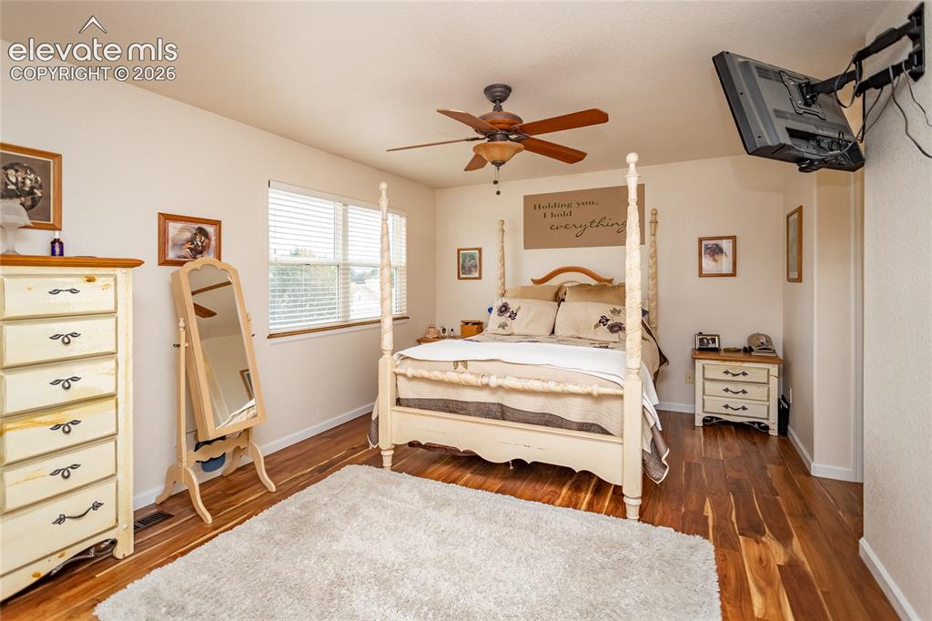 Image 25 of 44: The primary bedroom suite is a serene escape featuring elegant ceiling fans