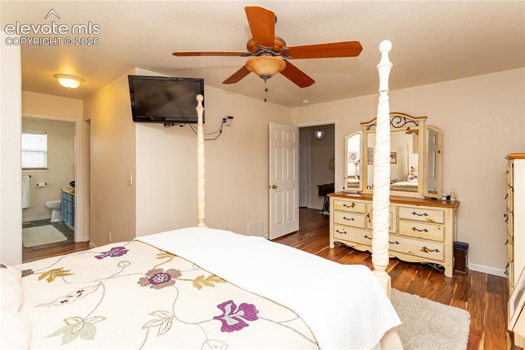 Image 27 of 44: Soft natural light fills the primary suite, which features a private adjoin