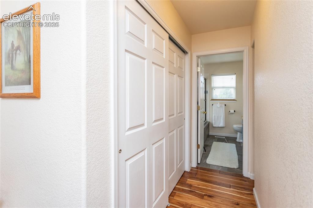 Image 32 of 44: A look down from the upper hallway showcases the masterfully crafted wood b
