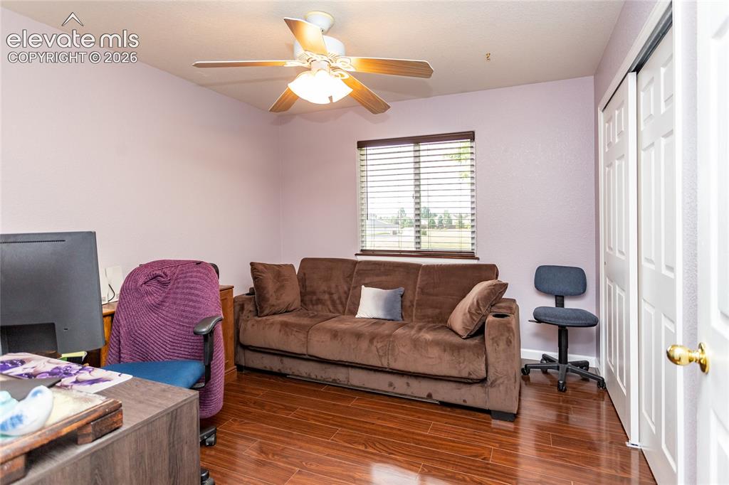 Image 33 of 44: The spacious second bedroom, styled here as a high-functioning home office,
