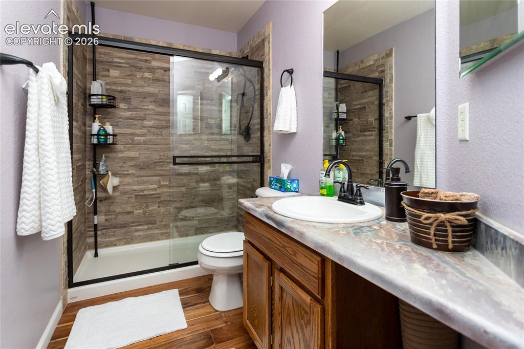 Image 35 of 44: The second upstairs full bathroom features a custom acrylic vanity top, upg