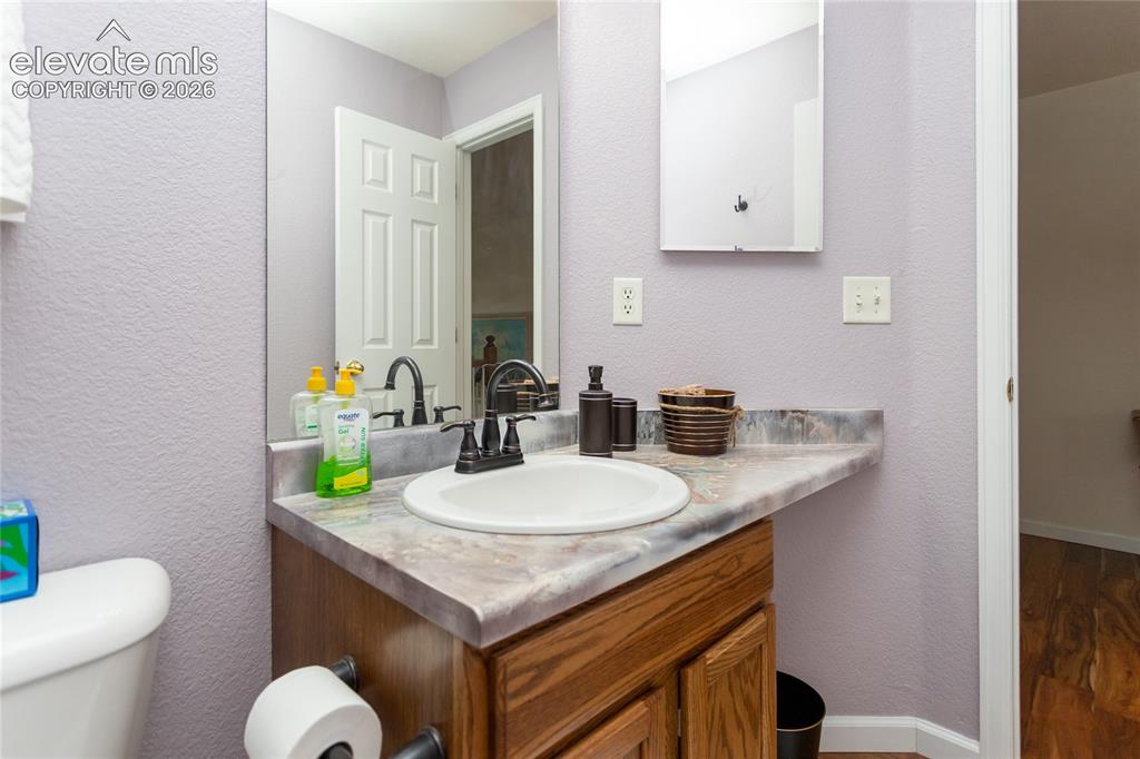 Image 37 of 44: A close-up highlights the custom-swirled, grey-and-white stone countertop a