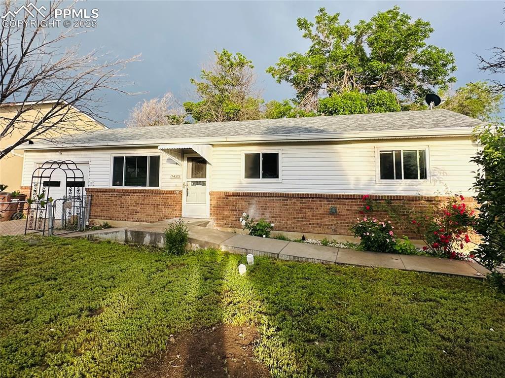 Caption: Ranch-style house with brick siding and a shingled roof