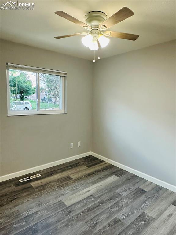 Image 14 of 17: Unfurnished room featuring dark wood finished floors and a ceiling fan