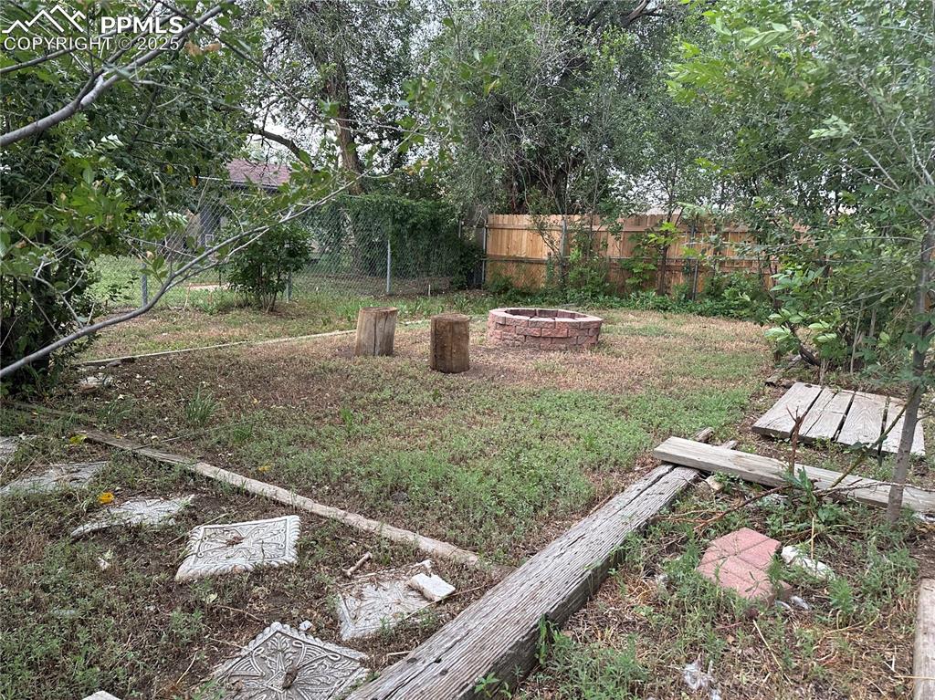 Image 15 of 17: View of yard with a fire pit