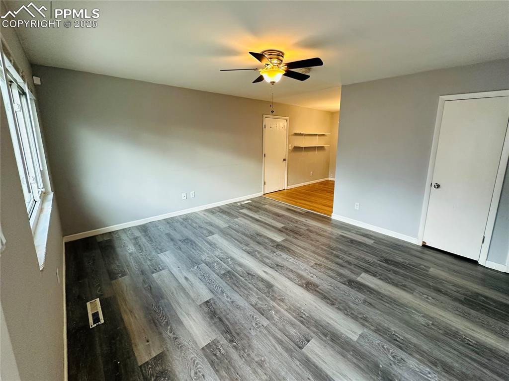 Image 4 of 17: Empty room featuring a ceiling fan and wood finished floors
