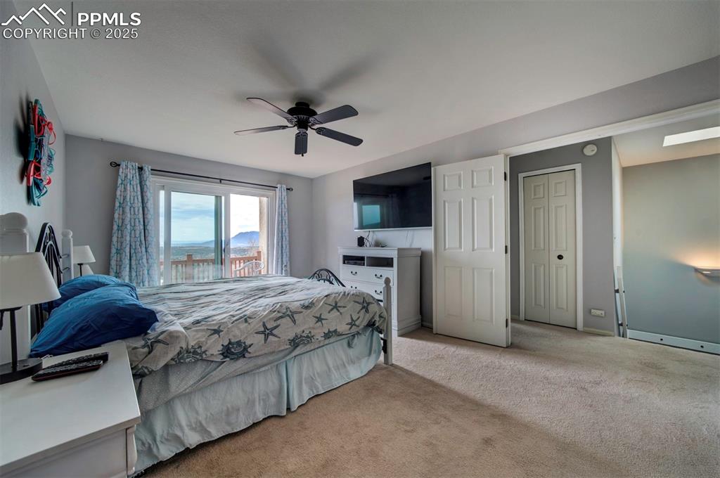 Image 12 of 44: Bedroom with carpet floors and ceiling fan