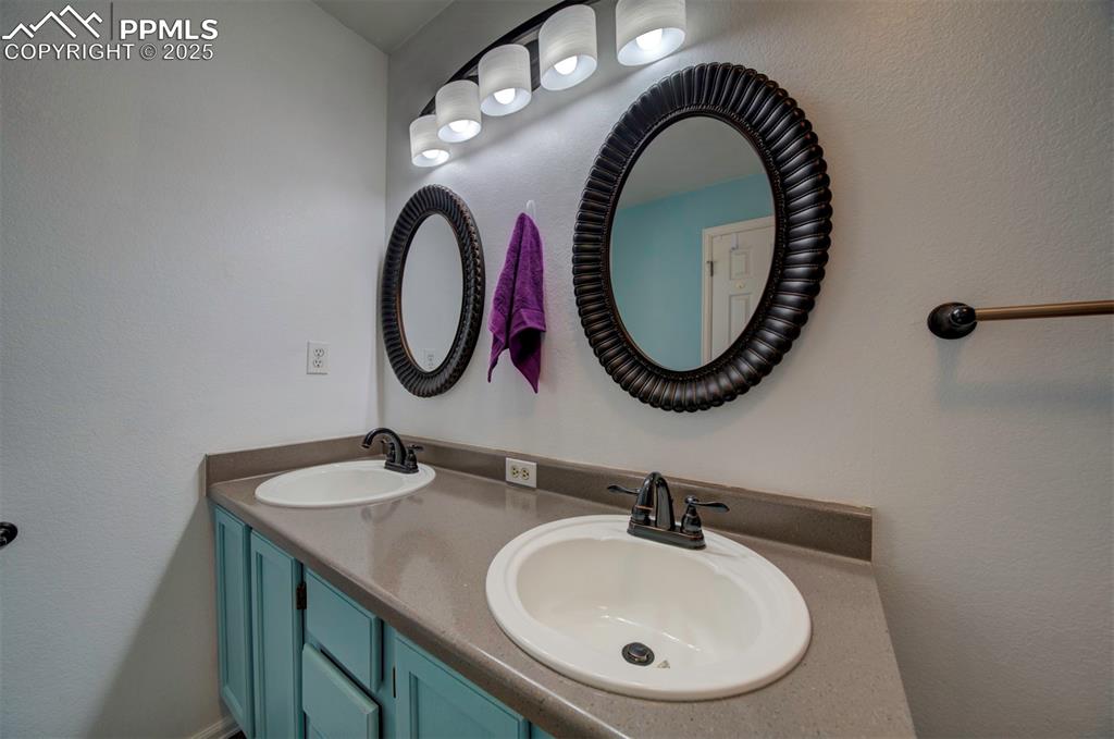 Image 14 of 44: Full master bath with double vanity and a textured wall