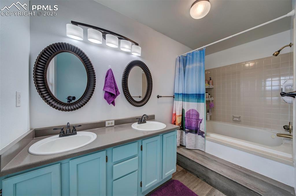 Image 16 of 44:  Master Bathroom featuring shower / bath combo with shower curtain, double 
