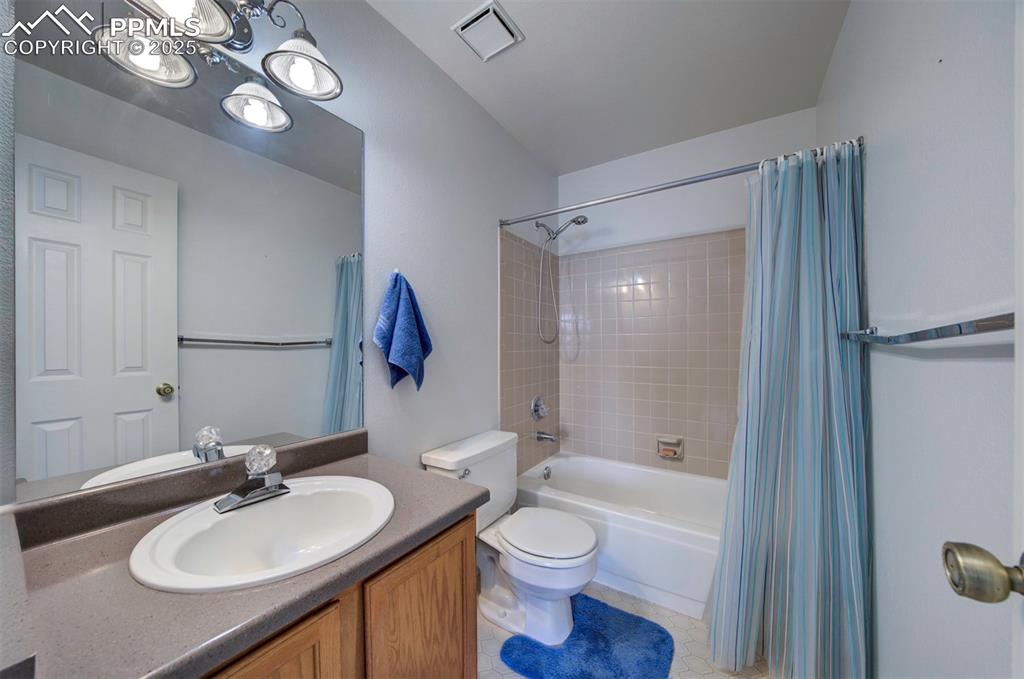 Image 24 of 44: Full 2nd  bathroom featuring shower / tub combo with curtain, vanity, and l