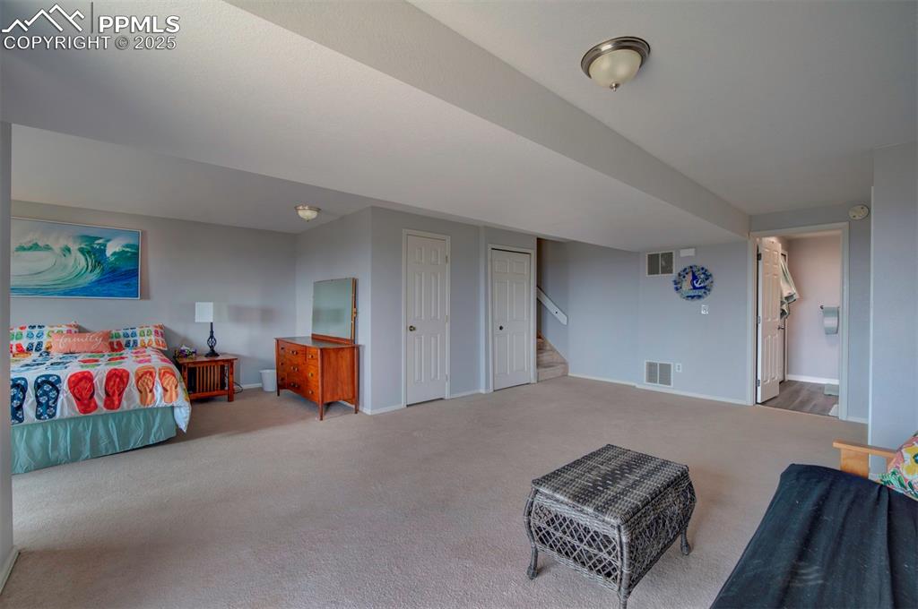 Image 29 of 44: Carpeted bedroom featuring baseboards and two closets
