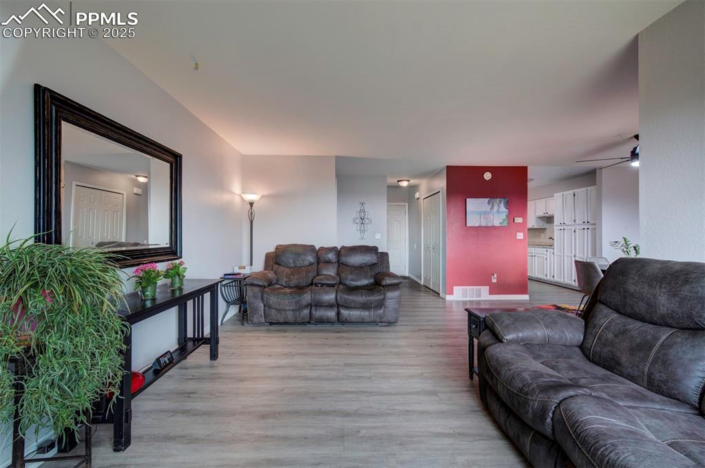 Image 5 of 44:  side view of Living area featuring light wood-style flooring and a ceiling