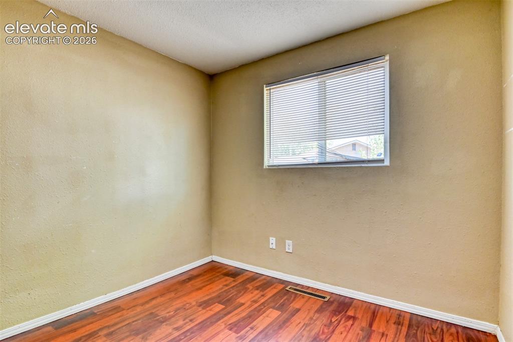 Image 16 of 35: Interior room featuring wood-finish flooring, light-colored walls, and a wi
