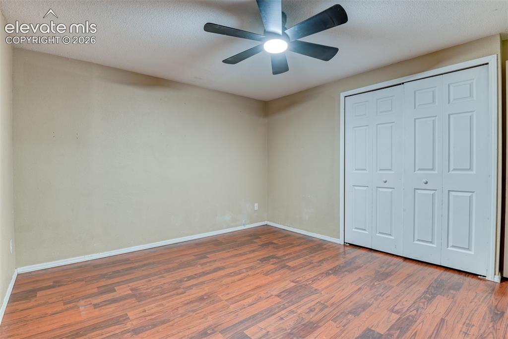 Image 20 of 35: Room featuring wood-finish flooring, a ceiling fan with integrated lighting