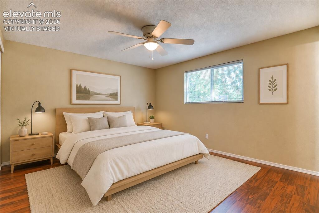 Image 23 of 35: Virtually staged Spacious room with wood-finish flooring, a contemporary ce