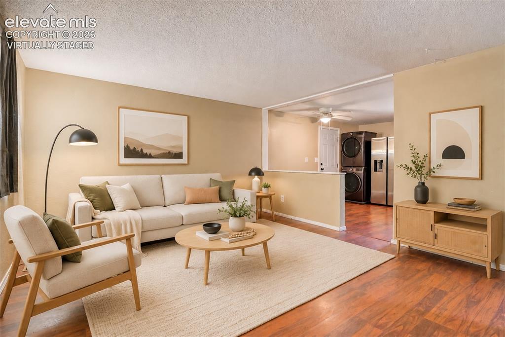 Image 4 of 35: Virtually staged Spacious living area featuring wood-finish  flooring, neut