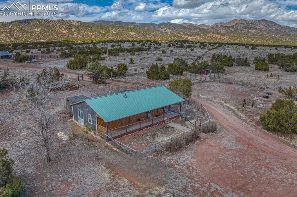 Image 2 of 45: Aerial view of sparsely populated area with a mountainous background