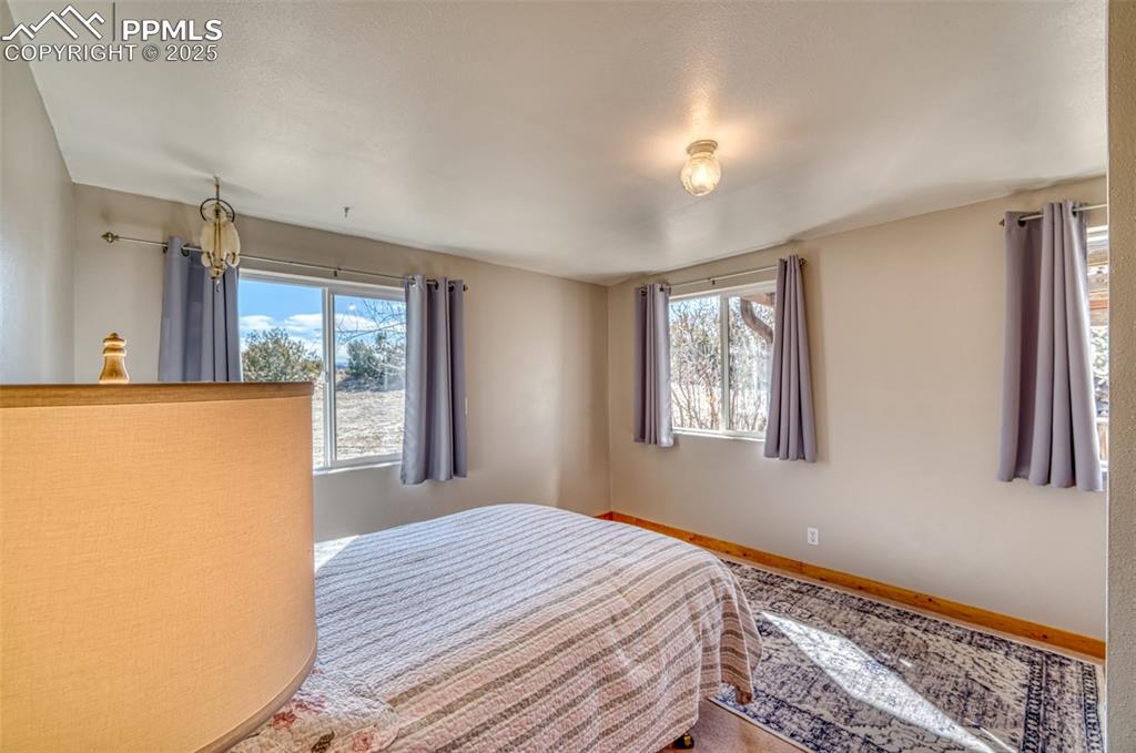 Image 20 of 45: Bedroom featuring multiple windows and baseboards