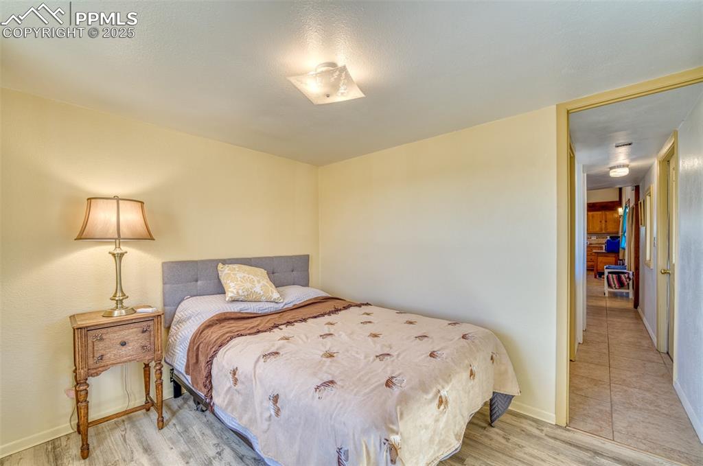 Image 22 of 45: Bedroom with wood finished floors and baseboards