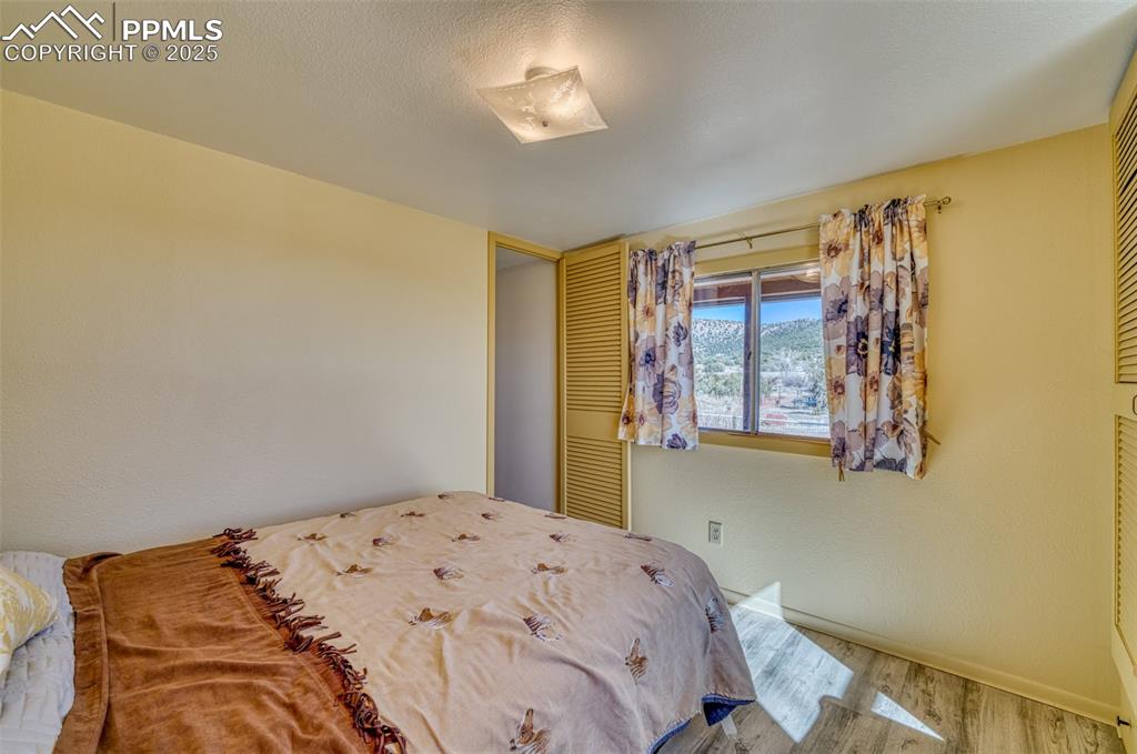 Image 23 of 45: Bedroom with wood finished floors and baseboards