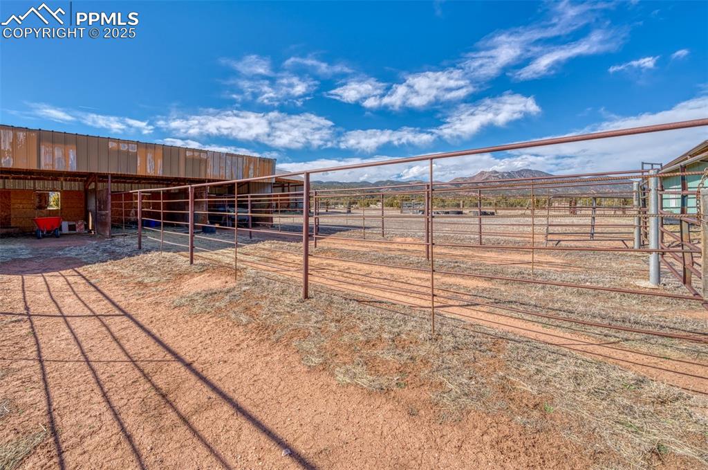 Image 30 of 45: View of yard with an exterior structure, a mountain view, and an outdoor st