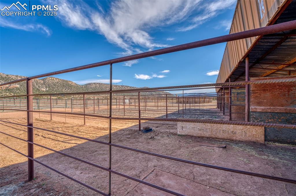 Image 31 of 45: View of yard with an exterior structure, a mountain view, and an outbuildin
