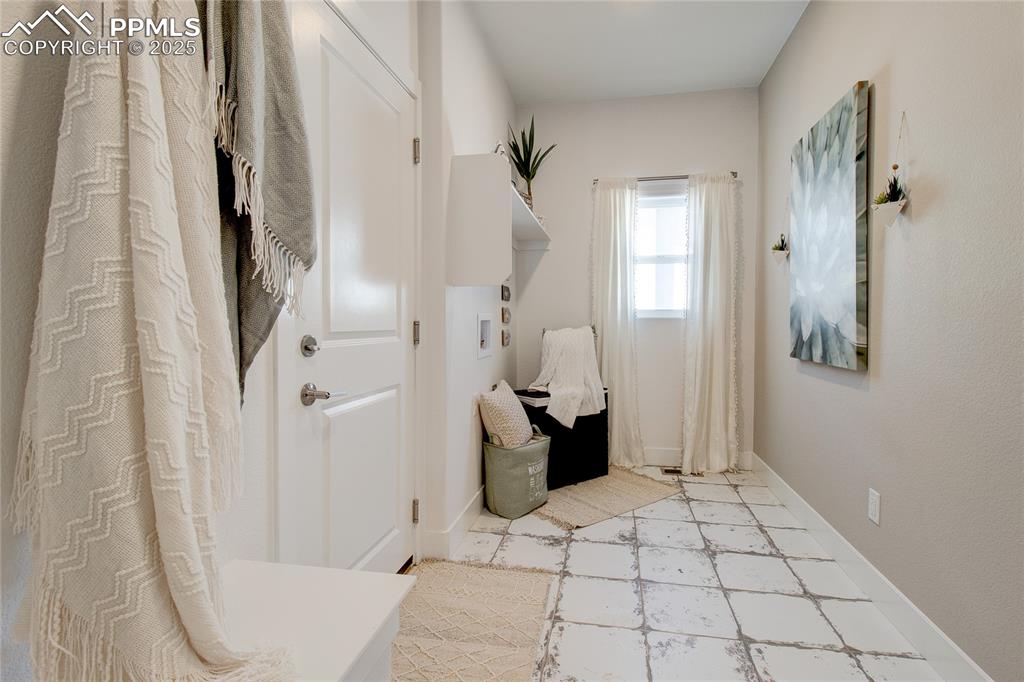 Image 12 of 27: Laundry room featuring washer hookup and light flooring