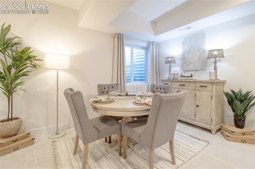 Image 23 of 27: Dining room featuring light carpet