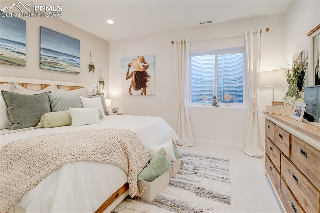 Image 25 of 27: Bedroom featuring light colored carpet and recessed lighting