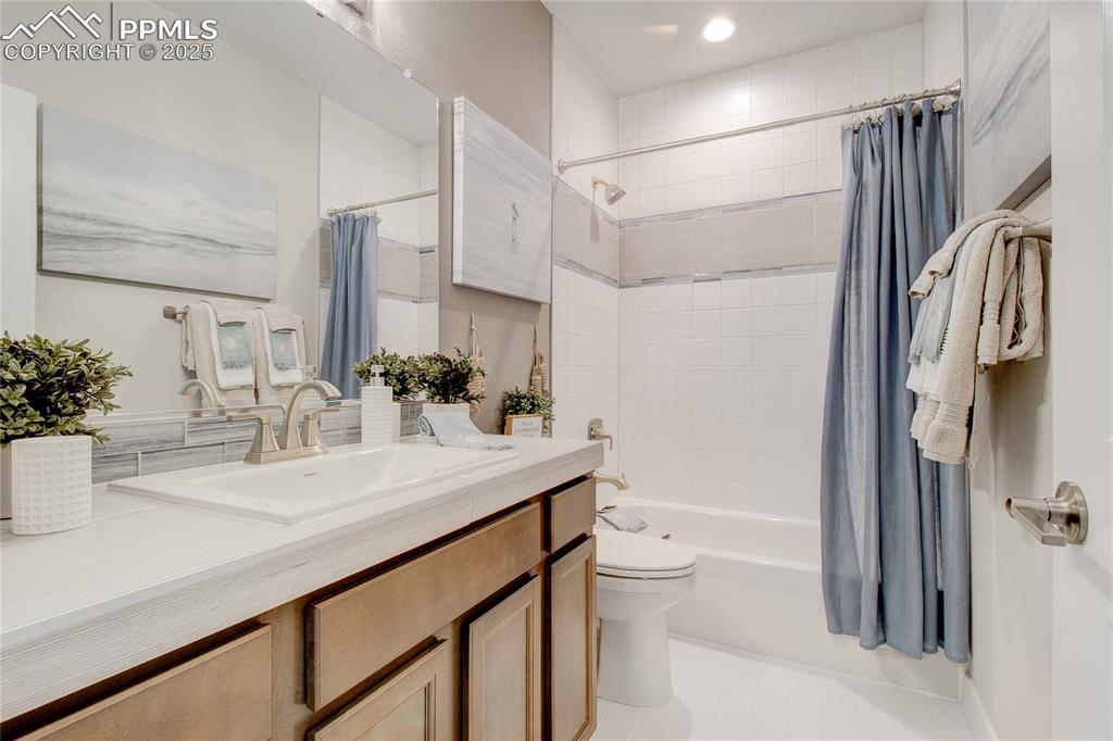 Image 27 of 27: Full bathroom featuring vanity, shower / tub combo, and recessed lighting