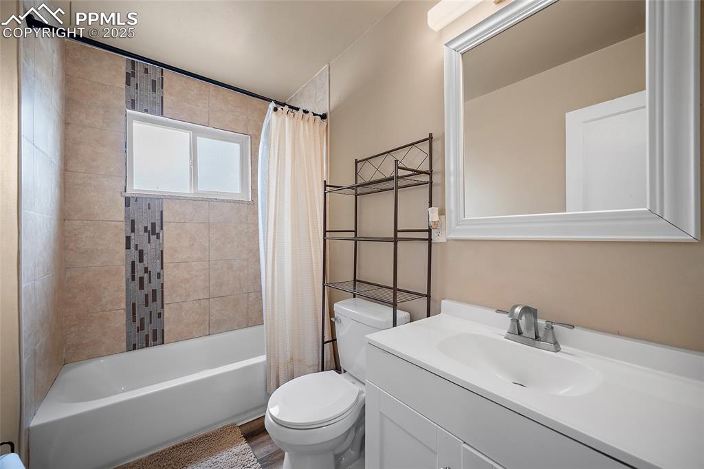 Image 6 of 12: Full bath with toilet, shower / bath combo, and vanity
