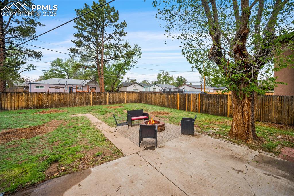 Image 9 of 12: View of patio with an outdoor fire pit