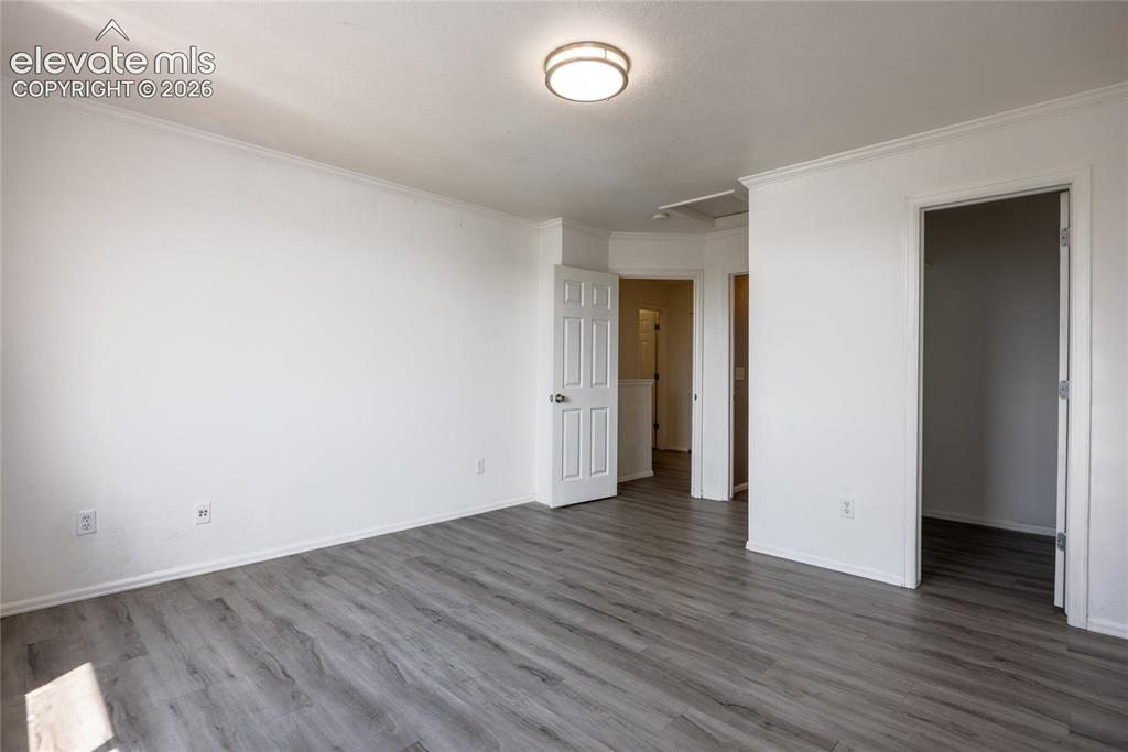 Image 15 of 31: Light gray wood-finish flooring, white walls, and a flush mount ceiling fix