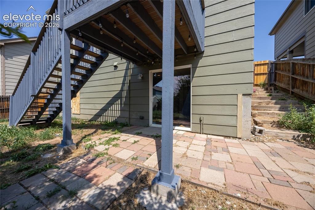 Image 27 of 31: Lower level patio space with paver flooring