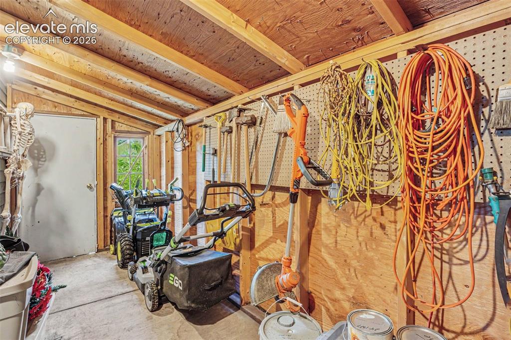 Image 24 of 27: Attached to the garage, the utility shed/workshop provides a practical spac