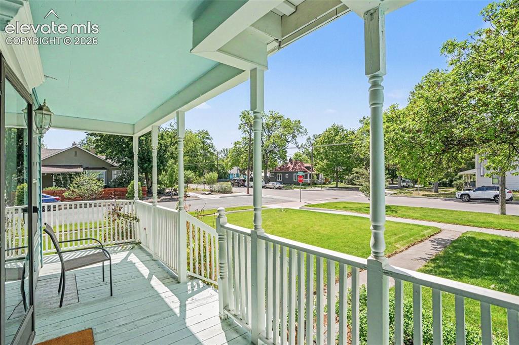 Image 3 of 27: The covered two-level front porch and deck showcase charming turn-of-the-ce