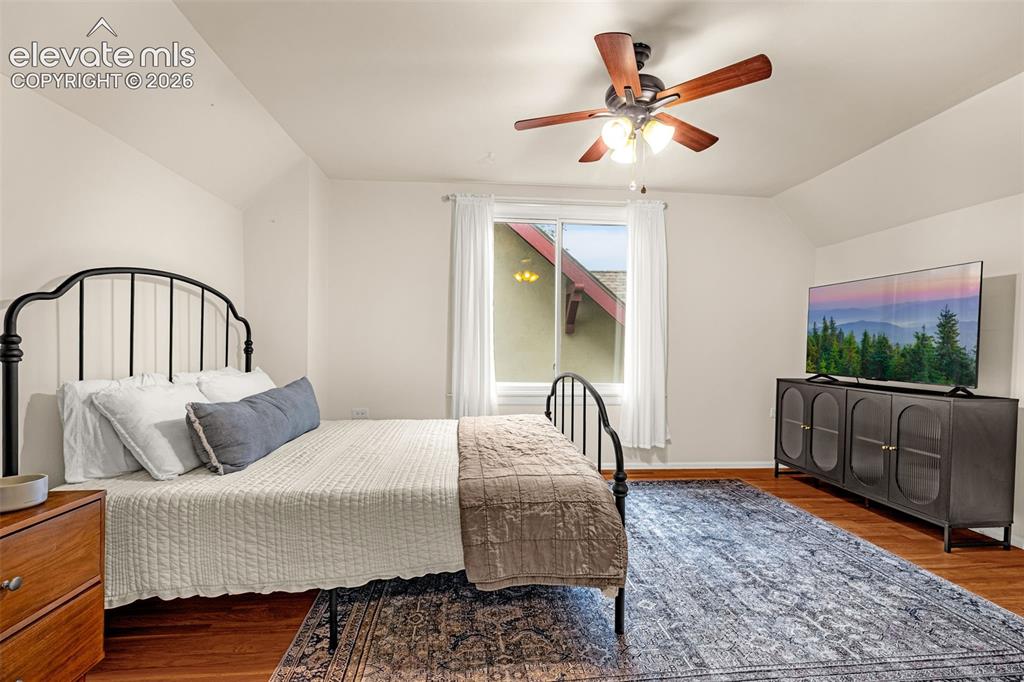 Image 20 of 33: Wood-finish flooring, ceiling fan with integrated lighting, and a window wi