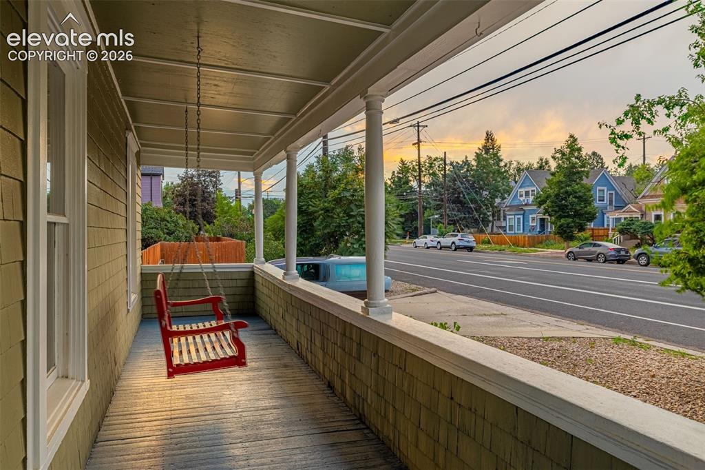 Image 30 of 33: Covered porch with porch swing
