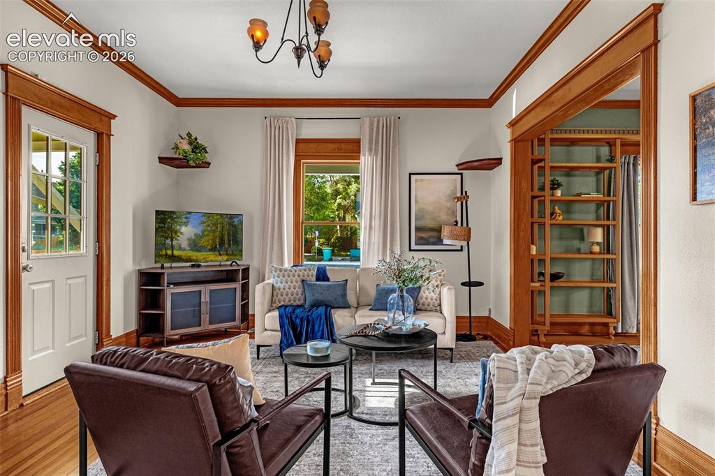 Image 7 of 33: Detailed wood-finish trim and crown molding throughout
