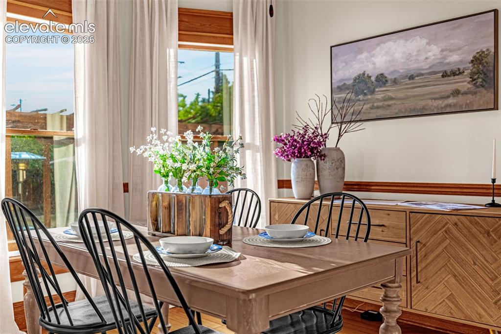 Image 9 of 33: Hardwood flooring, natural wood window trim, light wood dining table, built